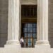 Guard standing on the Supreme Court steps.