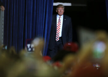 former President Donald Trump walking on stage