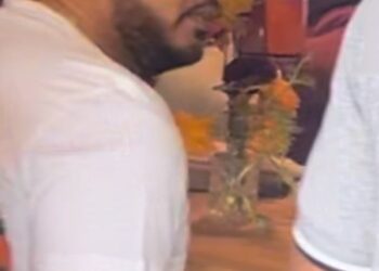 Male suspect sitting at a table