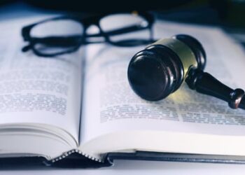 dictionary, gavel and glasses