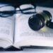 dictionary, gavel and glasses